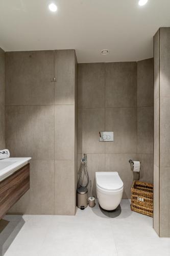 a bathroom with a toilet and a sink at Mercury Suites Apartment with Pool Access in St Julians in St. Julianʼs