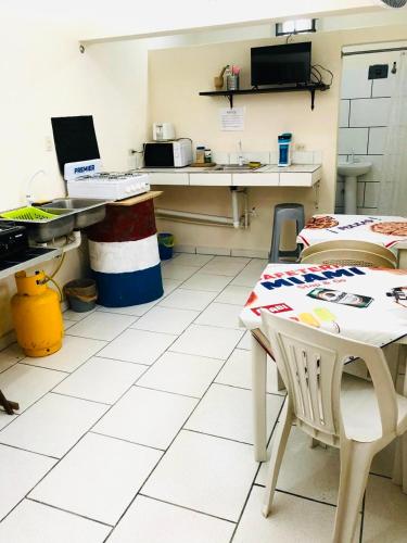 a kitchen with a table and chairs in a room at Miami Studios DR in Santo Domingo