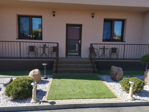 a house with a garden with rocks and grass at Velká Bukovina 