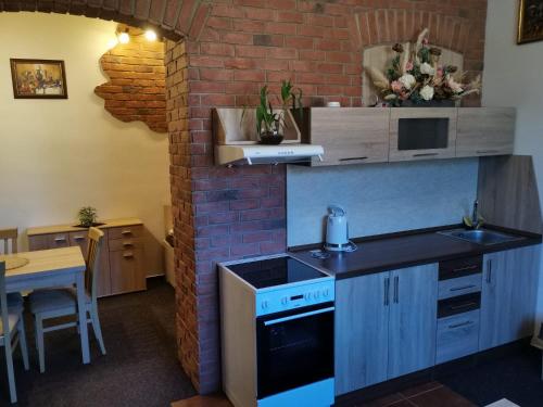a kitchen with a sink and a brick wall at Velká Bukovina 