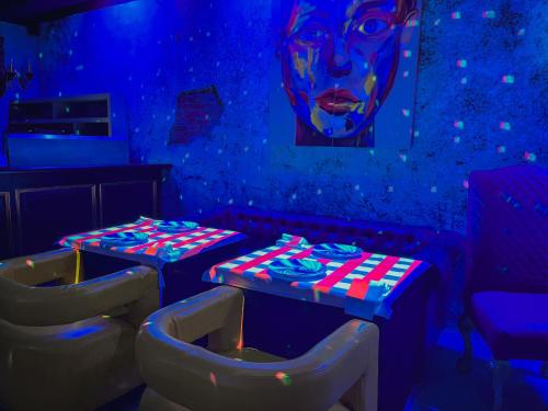 a room with two tables and a painting of a woman at Royal Solaris Los Cabos - All Inclusive in San José del Cabo