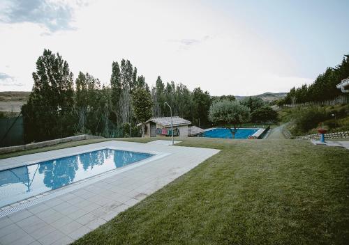 a swimming pool in the middle of a yard at La Posadica Casa Aldabe in San Martín de Unx