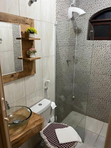a bathroom with a shower with a toilet and a sink at pousada vó biloca in Urubici