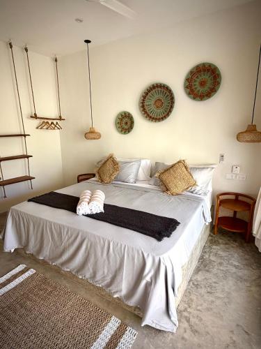 a bedroom with a large bed with pillows on it at Kaia Beach Lodge en Cosón in Las Terrenas