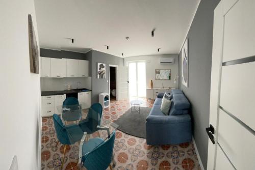 a living room with a blue couch and chairs at Vento di Sicilia in Carini