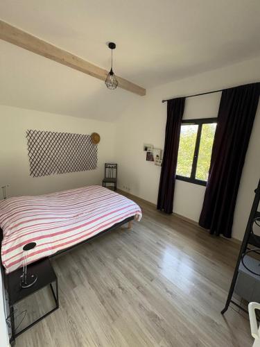 a bedroom with a bed and a wooden floor at La Félicita-Independent House-Terrace-8 Pers in Saint-Jean-de-Maurienne