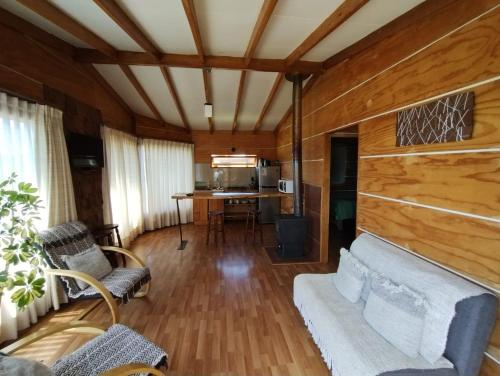 a living room with a couch and a table at Cabañas Pucatue in Pucatue