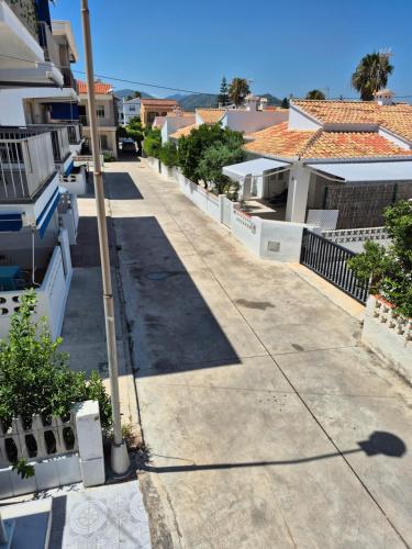 an empty street in a city with buildings at Hello Oliva Beach Roger in Oliva