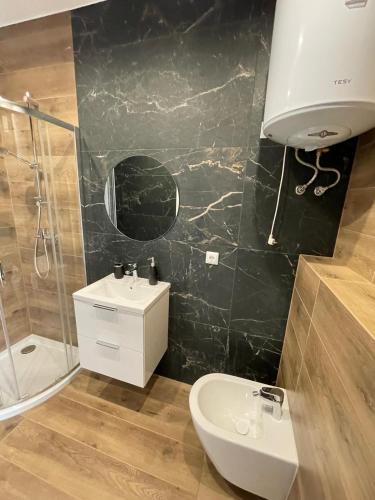 a bathroom with a sink and a toilet and a shower at Vento di Sicilia in Carini