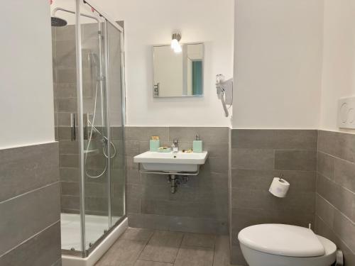 a bathroom with a toilet and a sink and a shower at B&B Santi Quattro Al Colosseo in Rome