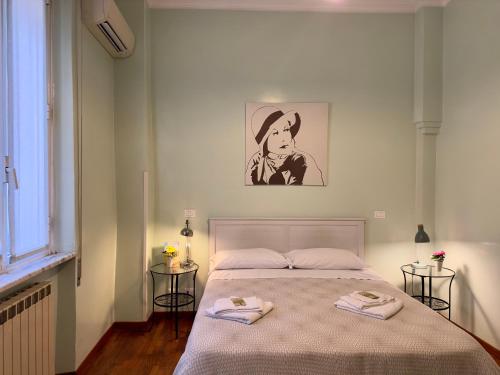a bedroom with a bed with two towels on it at B&B Santi Quattro Al Colosseo in Rome