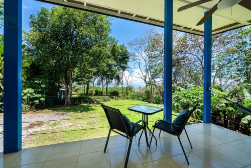 a patio with two chairs and a table with a view at Ocean View Modern Dream House 1 in Pavones