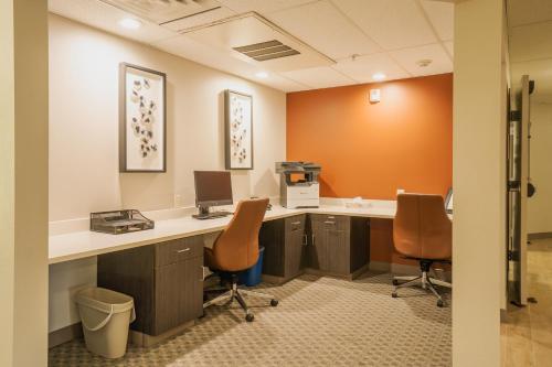 an office with a desk with a computer and two chairs at Candlewood Suites Boise - Towne Square by IHG in Boise