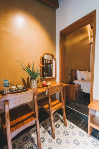 a room with a table and a mirror and a bed at Tam Coc Golden Fields Retreat in Vũ Lâm