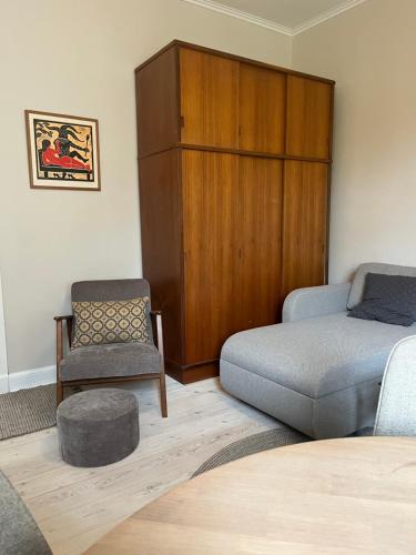 a living room with a bed and a chair at Lovely appartment in charming town house in Assens