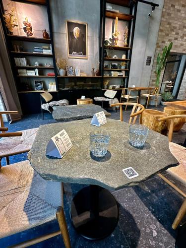 a table with two glasses on it in a room at Haas Apartments Art with parking, bakery, coffea in Brno