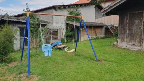 a playground with two swings in a yard at RoSa Seeblick in Steingädele