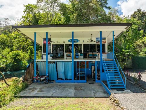 a small building with blue doors and a porch at Ocean View Modern Dream House 1 in Pavones