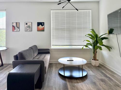 a living room with a couch and a table at 2B2B Condo in ATL Penthouse level 542Blvd402 in Atlanta