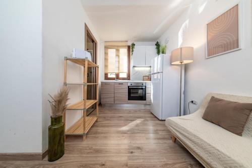 a living room with a couch and a white refrigerator at SASSARI-CENTRO Elegante Appartamento con WiFi e Netflix in Sassari
