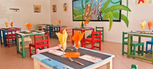 a restaurant with tables and chairs with umbrellas at Sentido Marillia Resort & Spa in Hammamet