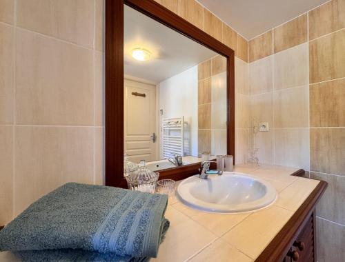 a bathroom with a sink and a large mirror at La Maison du Golf - Jardin - Piscine - 4p in LʼAiguillon-sur-Vie