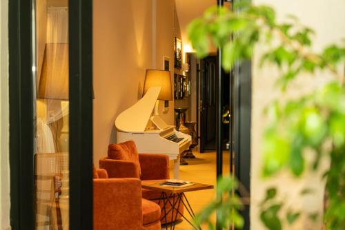 a living room with a chair and a lamp at Vila Lasko Hotel in Golem