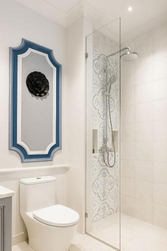 a bathroom with a toilet and a glass shower at The Grand Luang Prabang, Affiliated by Meliá in Luang Prabang