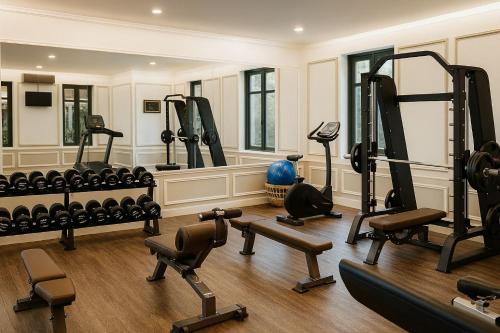 a gym with several treadmills and exercise equipment at The Grand Luang Prabang, Affiliated by Meliá in Luang Prabang