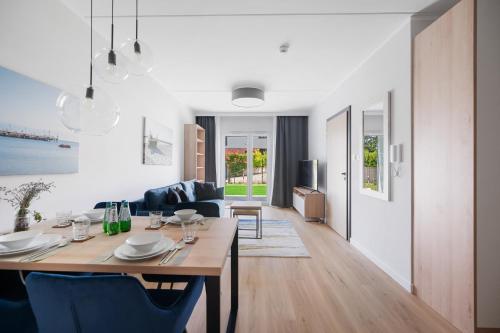 a dining room and living room with a table and chairs at ReVital Mechelinki by Homeprime Parking Free in Mechelinki