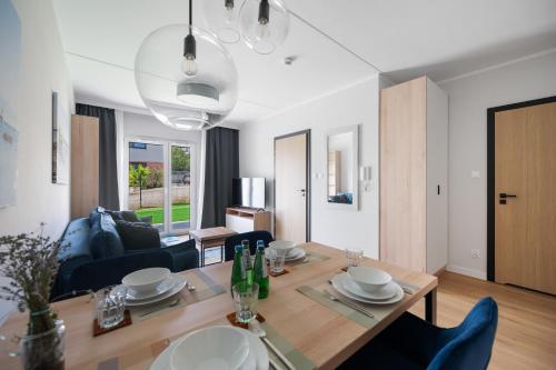 a dining room and living room with a table and chairs at ReVital Mechelinki by Homeprime Parking Free in Mechelinki