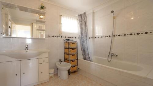 a bathroom with a sink and a toilet and a bath tub at R-2428 APARTAMENTO CORINTO in La Mata