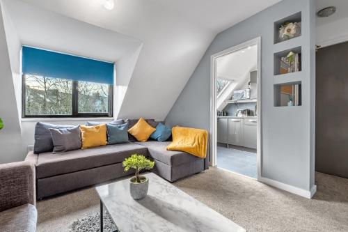 a living room with a couch and a table at Jesmond 2BR Apartment with Parking & WiFi in Jesmond