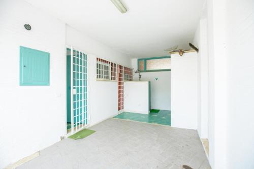 an empty room with white walls and a blue door at Sea View Suite with Parking and Private Garden in Anzio