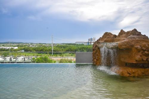 a fountain in the middle of a body of water at Macrolink Medini Theme Suite by Nest Home - Near Legoland in Iskandar Puteri