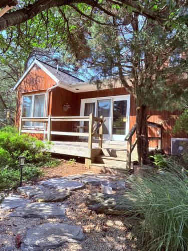 a small house with a porch and a fence at HIllside Farm B & B in Mount Joy