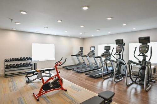 a gym with several treadmills and exercise bikes at Holiday Inn Express Houghton-Keweenaw by IHG in Houghton
