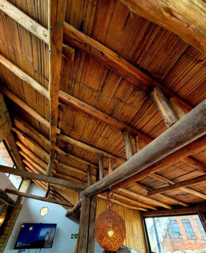 a wooden ceiling with a chandelier in a room at Arche Noah Boutique Hostel in Bogotá