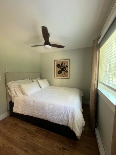a bedroom with a bed and a ceiling fan at The Owls Nest at Westwood Lake in Nanaimo