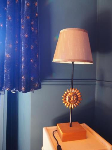 a lamp sitting on top of a table at La Sorcière et le Korrigan in Paimpont
