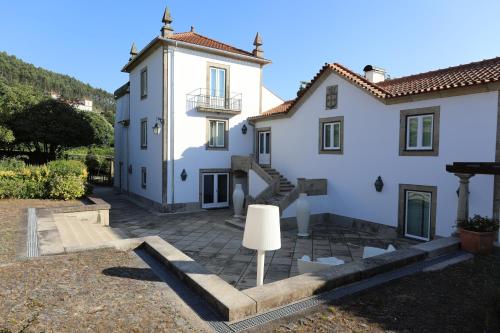 a large white house with a staircase in front of it at Casa dos Macieis - Entire Main House, Entire Guesthouse or Separate Wing of Main House - Camino Santiago direct access & Optional Agritourism in Facha