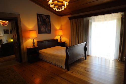 a bedroom with a bed and a large window at Casa dos Macieis - Entire Main House, Entire Guesthouse or Separate Wing of Main House - Camino Santiago direct access & Optional Agritourism in Facha