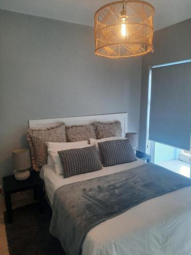 a bedroom with a large bed with pillows on it at Pips Place 203 in Strand