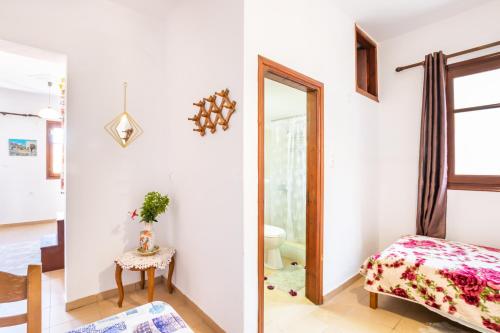 a bedroom with a mirror and a bed and a table at SofiaMikeHouse in Olympos