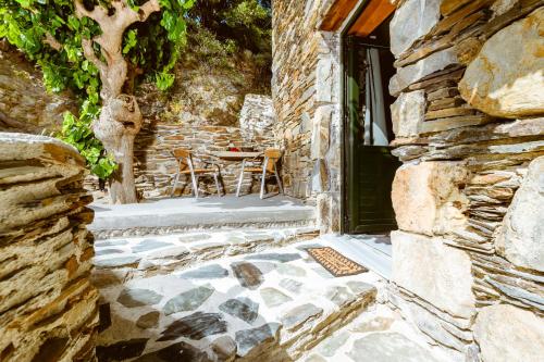 an entrance to a stone house with a table and chairs at Ellafos Traditional Living in Elafonisi