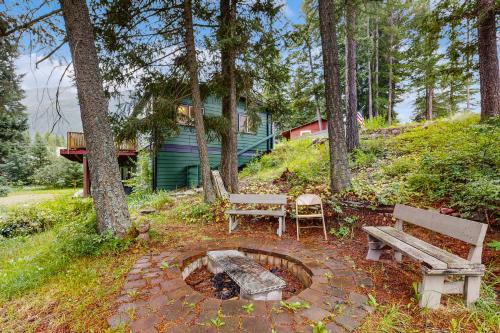 a park with two benches and a fire pit at Hungry Horse Hideout - Upper Level in Hungry Horse