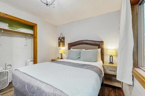 a bedroom with a large bed and a window at Hungry Horse Hideout - Upper Level in Hungry Horse