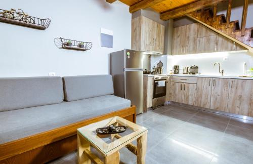 a living room with a couch and a kitchen at Ellafos Traditional Living in Elafonisi
