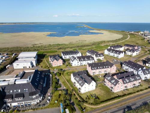 an aerial view of a town with houses and the ocean at TUI BLUE Sylt in Rantum