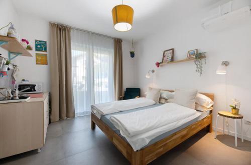 a bedroom with a bed and a large window at PEONIA 2 posti Wi-Fi AC free park Jacuzzi in Porlezza
